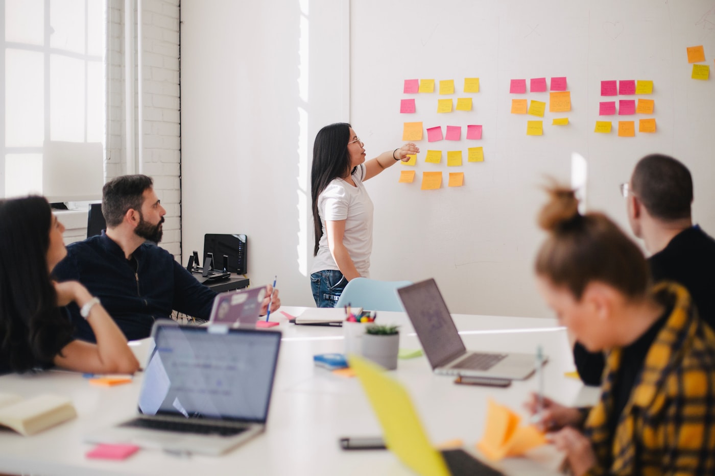 A team working through a plan at a whiteboard